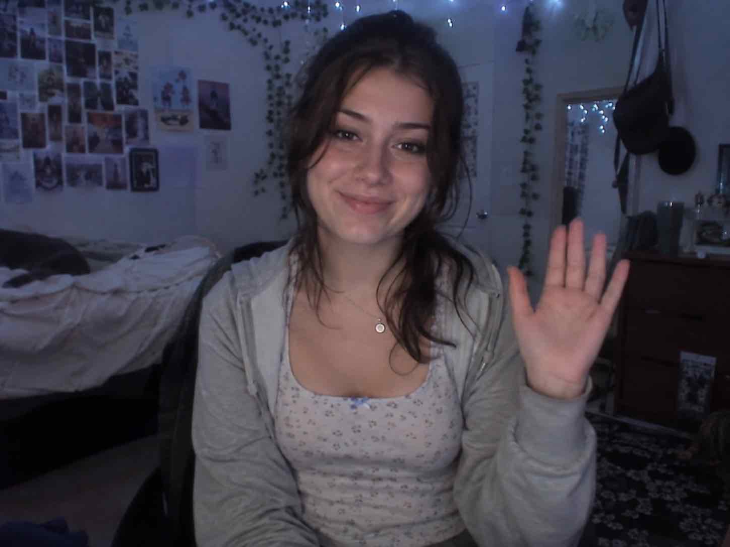 A person smiling and waving at the camera